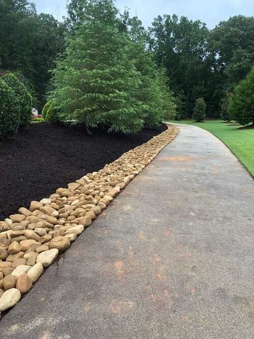 Stone-edged bed beside a walkway